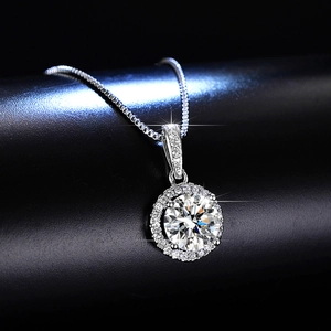 Macro shot of 1 carat moissanite halo pendant with brilliant round-cut center stone