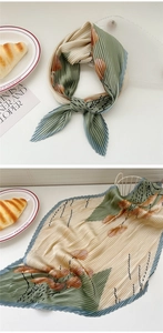 Detail of pleated silk scarf with floral print and crinkle texture for women