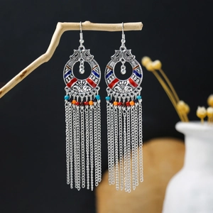 Detail of vintage bohemian tassel earrings with colorful beads and antique silver finish