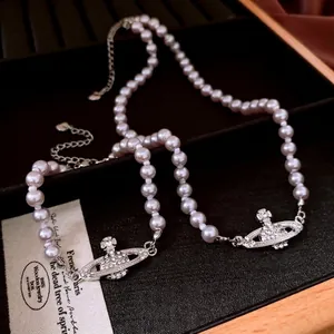 Elegant purple pearl necklace with crystal orb planet pendant on black velvet case
