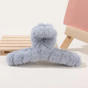 Close-up of a light blue plush hair claw clip featuring soft faux fur texture and sturdy grip