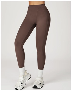 Detail view of high-waist yoga pants in coffee brown with V-shaped stitching detail