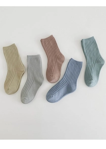 Close-up of five pairs of Morandi colored ribbed cotton socks for kids on white background