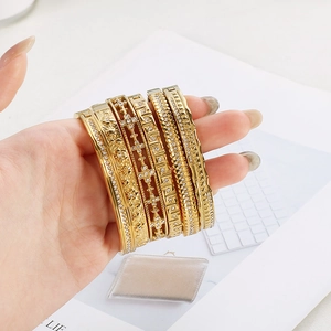 5-piece set of 18K gold plated stainless steel bangles with crystal inlay on a model hand