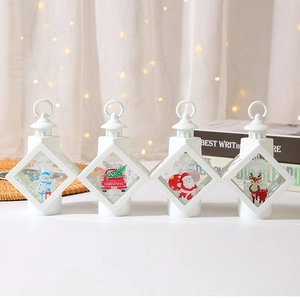 Set of four white Christmas lanterns with snowman and Santa patterns for festive table decor