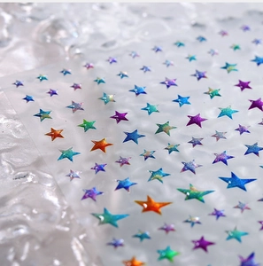 Macro shot of 3D colorful glitter star nail stickers with holographic laser finish