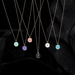 Gold plated star and moon enamel pendant necklaces in various colors on black stone