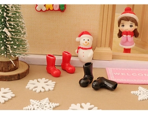 Miniature dollhouse Christmas boots in red and black plastic for festive DIY scenery