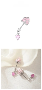 Detail of pink cupcake navel piercing with heart zircon in shell display