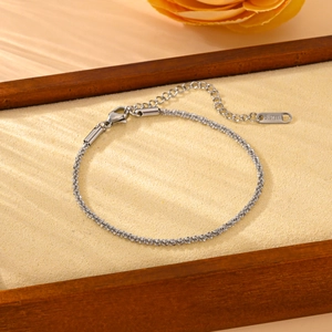 Elegant silver stainless steel twist chain bracelet on a premium velvet jewelry tray