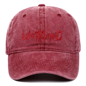 Close-up of gothic Lost My Head embroidery on washed burgundy cotton baseball cap