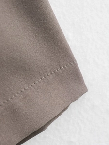 Close-up of professional stitching and durable coffee brown cotton-blend fabric texture