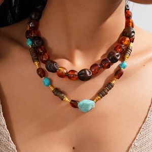 Close-up of bohemian double-layered necklace with turquoise and amber acrylic beads