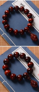 Macro detail of sandalwood beads and Maitreya Buddha pendant on blue book background