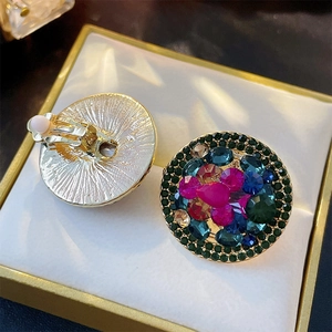 Detailed view of vintage round clip-on earrings with colorful pave-set rhinestones