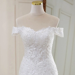 Elegant off-shoulder white lace wedding dress with intricate floral embroidery and sequins