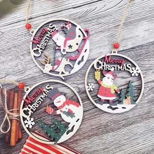 Close-up of three circular wooden Christmas ornaments with festive hollowed-out patterns