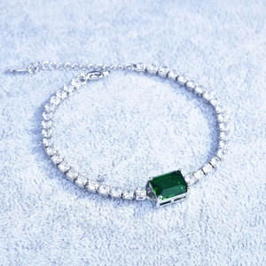 Detailed macro view of the emerald cut bracelet with silver chain and crystal accents