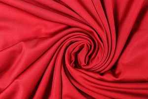Detail shot of the red ruched knit fabric texture and high-quality polyester sheen