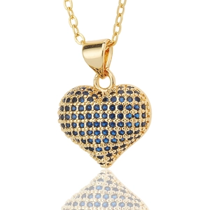 Detail of gold heart pendant necklace with blue pavé-set cubic zirconia stones