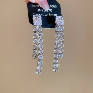 Close-up of S925 silver fringe earrings with square zircon crystals and luxury tassels