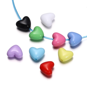 Macro shot of colorful heart-shaped acrylic beads for DIY jewelry and phone chain making