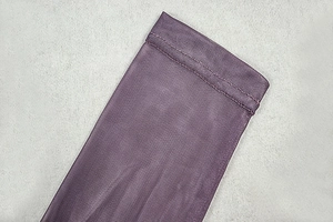 Detailed close-up of purple sheer mesh fabric showing fine texture and reinforced stitching