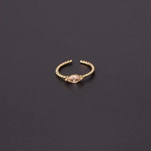 Detail of adjustable gold ring with beaded band and marquise cut cubic zirconia