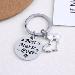 Stainless steel Best Nurse Ever keychain with nurse hat heart charm on white background