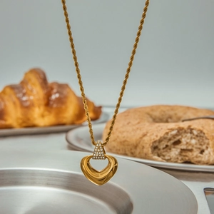 Elegant gold heart pendant necklace with clear stones and twisted rope chain style