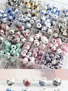 Macro detail of blue and white ceramic beads with floral patterns for DIY jewelry