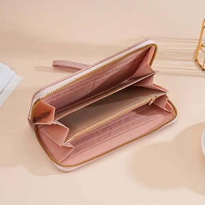 Pink long wallet with wristlet showing spacious card slots and zipped pocket