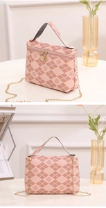 Detail of pink quilted handbag showing clover print, golden chain, and dual zippers