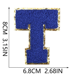 Close-up of blue chenille letter T patch with gold sequin border, 8cm tall DIY applique