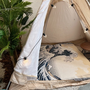 Detail of bohemian fringe edge on Ukiyo-e wave pattern woven blanket for camping