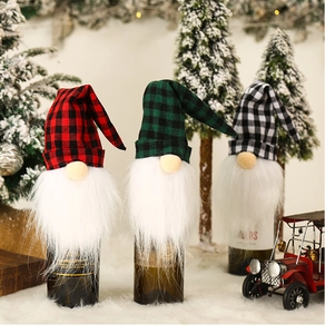 Close-up of Christmas gnome wine bottle covers in red, green and white plaid patterns