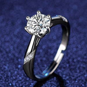 Macro side view of six-prong moissanite ring with side accent diamonds on blue background