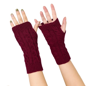 Close-up of wine red cable knit fingerless gloves showing detailed braided texture