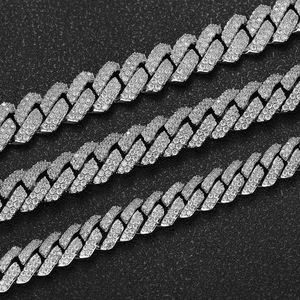 Macro detail of silver-toned Cuban link chains encrusted with sparkling zircon stones