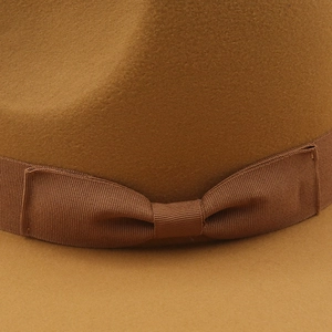 Detailed close-up of a camel wool felt fedora featuring a grosgrain ribbon bow