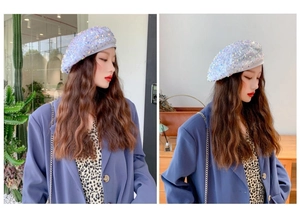 Side view of shimmering light blue sequin beret showing stylish silhouette and fit