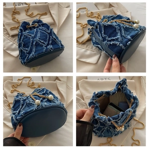 Detail view of denim bucket bag showing side profile, base and interior storage