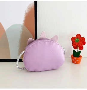 Detail of purple unicorn crossbody bag for girls with leather texture and silver strap
