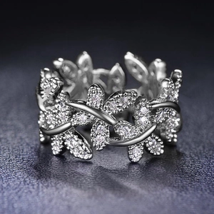Elegant silver vine leaf ring with shimmering zircon crystals on textured black leather