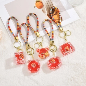 Detailed set of acrylic liquid capybara charms with floating glitter and woven straps