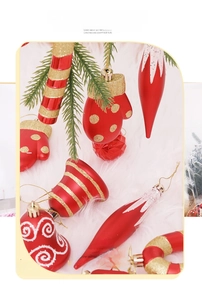 Festive red and gold Christmas ornaments including bells and candy canes on white fur