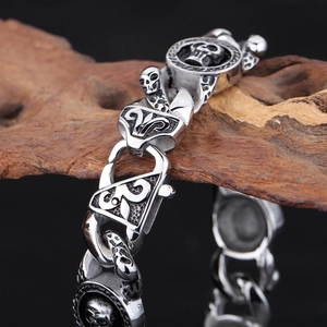Vintage punk skull bracelet for men in silver finish resting on a natural wood bark