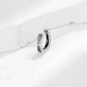 Silver 925 hoop earrings with Roman numerals and cubic zirconia on stone background