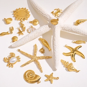 Golden ocean theme charms with starfish and shells on white background for DIY jewelry