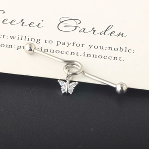 Detailed close-up of a silver butterfly industrial barbell with marquise cubic zirconia